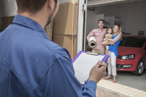 Local removals team handling furniture in a West Hampstead street
