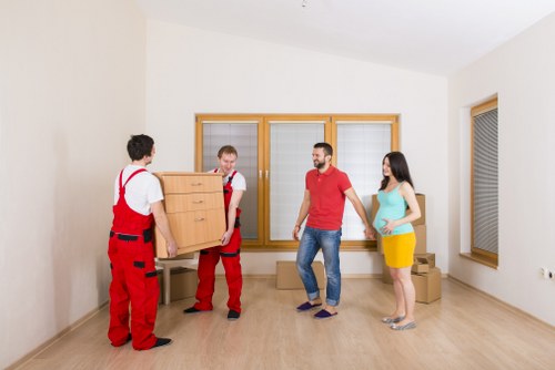 Office movers handling desks and equipment in a local commercial building