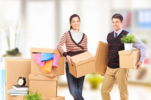 Packed moving boxes and furniture ready for collection in a West Hampstead flat