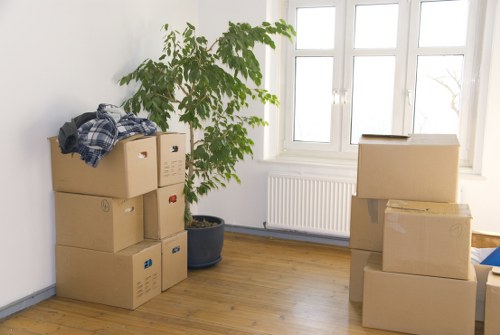 Movers handling furniture in a West Hampstead flat