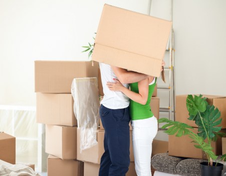 Movers carrying furniture through a West Hampstead property staircase