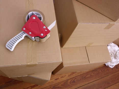 Removal van and moving boxes in a West Hampstead residential street