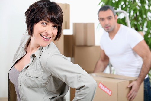 A coordinated office move with desks, boxes, and equipment ready for transport