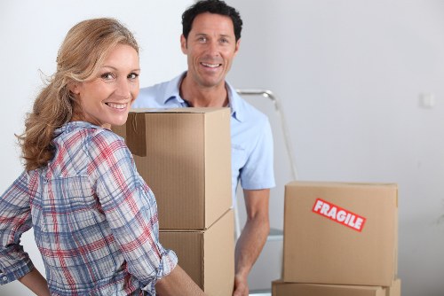 Movers carrying furniture from a West Hampstead flat