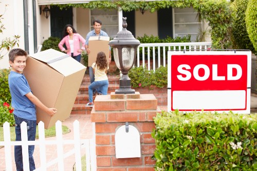 Local removals team handling boxes and furniture in West Hampstead